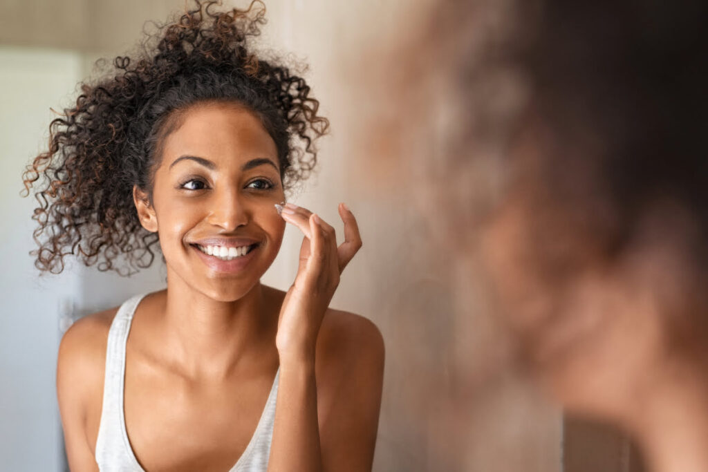 Woman checking her face in the mirror